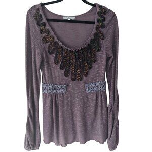 Purple long sleeve top with fabric embellishments